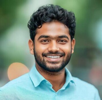 a smiling young indian man with formal shirts outdoors photo