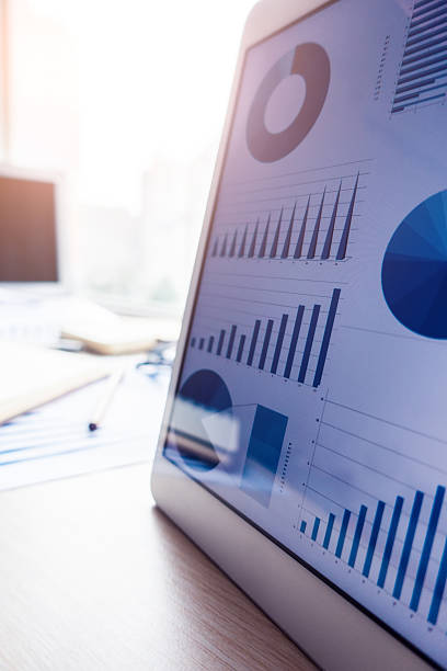 workplace with tablet pc showing charts